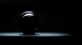 Dark scenery of a glass ball surrounded by darkness.