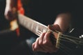 Dark scenery with woman playing chord on electric guitar Royalty Free Stock Photo