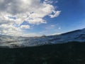 Dark sea water and cloudy blue sky double landscape photo. Tropical seaside banner. Royalty Free Stock Photo