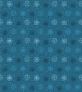 Dark seamless pattern of many light snowflakes on blue background. Soft Christmas winter theme for gift wrapping. New Year