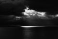 Dark Seascape with Black Sea and Sky and One Beam of Light