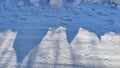 A dark shadow on the snow looks like a city with houses, domes, buildings. Background and texture for a fantastic Royalty Free Stock Photo