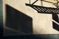 Dark shadows of fire escape and sign on side of stucco building Royalty Free Stock Photo
