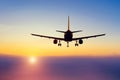 Dark shiny silhouette of an airplane landing during dawn and morning fog Royalty Free Stock Photo