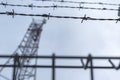 Dark silhouette of barbed wire fence near the prison. Royalty Free Stock Photo