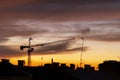 Dark silhouette of city roofs and construction crane on night sky background. Royalty Free Stock Photo