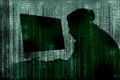 Silhouette of cyber criminal hacking computer behind digital symbols