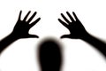 Dark silhouette of female hands and head on white background, concept of fear