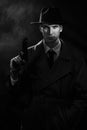 A dark silhouette of a man in a raincoat and hat with a gun in his hands in the style of crime noir. A dramatic noir