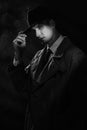 a dark silhouette of a man in a raincoat and a hat in the style of crime noir. A dramatic noir portrait in the style of