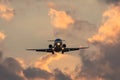 Dark silhouette of an small airplane at sunset approach in the airport of a beautiful beautiful sky. Royalty Free Stock Photo