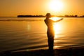 Silhouette of woman dancing tradition trible oriental near big river coast at dawn