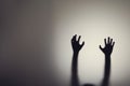 Silhouette of woman hands behind glass door. Concept of depression, fear, panic attacks