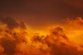 Dark silhouettes of clouds in the orange sky