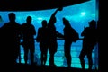 The dark silhouettes of people in the backlight of the main tank