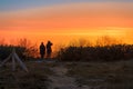 dark silhouettes of 2 people watch the orange sunset on the beach of RÃ¼gen on the Baltic Sea. Royalty Free Stock Photo