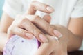 Dark skin woman applying whitening cream on hand, Beauty concept