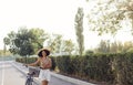 Dark skinned female teenage is driving her bicycle. Young and positive afro american girl in casual cloth smiles sweetly and has a Royalty Free Stock Photo