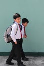Dark-skinned Latino boys carry their backpacks and walk back to school to study and learn Royalty Free Stock Photo