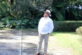 Dark-skinned Latino 50 year old man dressed in guayabera and hat, traditional Latin American dress, enjoys a walk outdoors