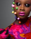 Close up beauty portrait african woman with creative make up in studio. Art portrait in bright dress on gray background in studio Royalty Free Stock Photo