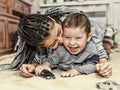 Dark-skinned mother plays with her son. Latin American Mom plays and laughs with his little son. Concept: Happy Mother`s Day Royalty Free Stock Photo