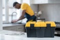 Dark-skinned service man working in the kitchen and looking concentrated on work