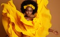 Dark Skinned Woman Fashion Portrait in Yellow Flying Dress. Beauty African Model with Flower Wreath in Black Afro Hairstyle.