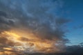 Dark sky with blak clouds brings storm rain at the sunset