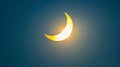 Dark sky with a bright crescent sun in a partial solar eclipse. Concept of solar eclipse, sky phenomenon, astronomy Royalty Free Stock Photo