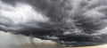 The dark sky with heavy clouds converging and a violent storm before the rain.Bad or moody weather sky and environment. carbon Royalty Free Stock Photo