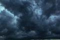 The dark sky with heavy clouds converging and a violent storm before the rain.Bad or moody weather sky and environment. carbon Royalty Free Stock Photo