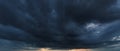 The dark sky with heavy clouds converging and a violent storm before the rain.Bad or moody weather sky and environment. carbon Royalty Free Stock Photo