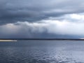 Dark sky over the lake before a thunderstorm. Royalty Free Stock Photo