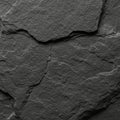 Dark slate rock texture with an uneven surface and distinct layers. The image shows Royalty Free Stock Photo