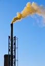 Dark smoke from a chimney against blue sky Royalty Free Stock Photo