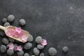 Dark Spa background with pebbles and flowers Royalty Free Stock Photo