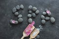 Dark Spa background with pebbles and flowers Royalty Free Stock Photo