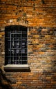 A dark window in an old brick wall Royalty Free Stock Photo