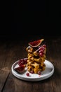 Dark still life, breakfast waffles, fresh figues, red