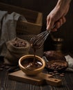 Dark still life with melted chocolate in wooden bowl Royalty Free Stock Photo