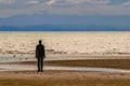 A Silhouette figure facing the horizon at Crosby Beach,England