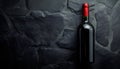 Dark stone backdrop with a bottle of red wine Royalty Free Stock Photo