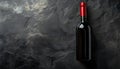 Dark stone backdrop with a bottle of red wine Royalty Free Stock Photo