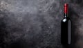 Dark stone backdrop with a bottle of red wine Royalty Free Stock Photo