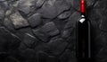 Dark stone backdrop with a bottle of red wine Royalty Free Stock Photo