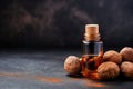 Dark stone background with nutmeg essential oil Royalty Free Stock Photo