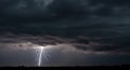 Dark Storm Cloud with Bright Lightning Strike Over Landscape Royalty Free Stock Photo