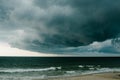 A dark storm cloud hovers over the Atlantic Ocean.