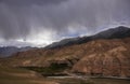 Dark storm cloud over mountain range and valley in Asia Royalty Free Stock Photo